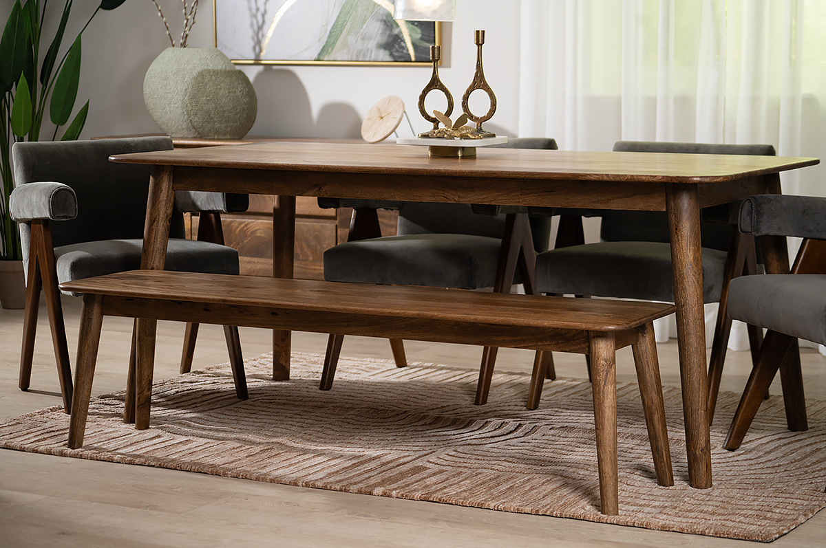 wooden dining table with wooden bench and fabric chairs